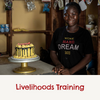 A women smiling sitting next to a yellow cake on the table with the captions 'livelihood training'